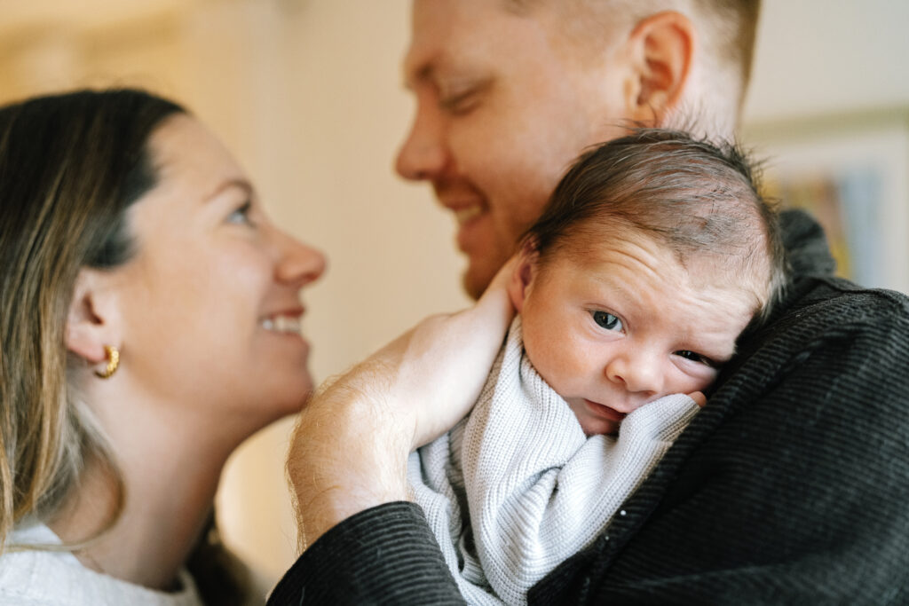 Emotional close-up of parents holding their newborn
