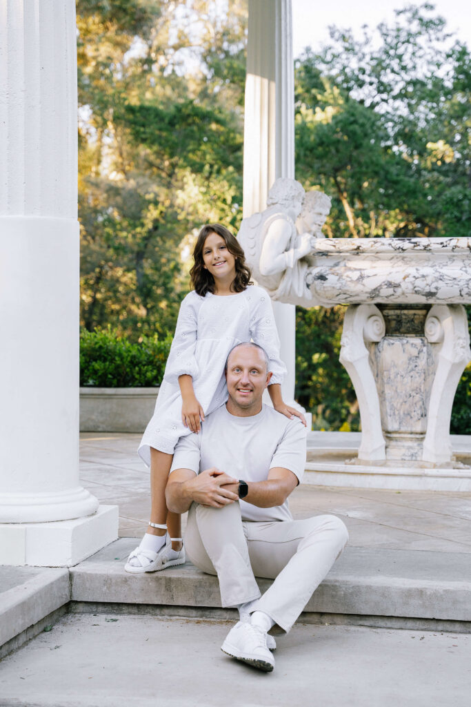 Family photography at Villa Montalvo Saratoga — father and daughter posing by historic columns and sculpture