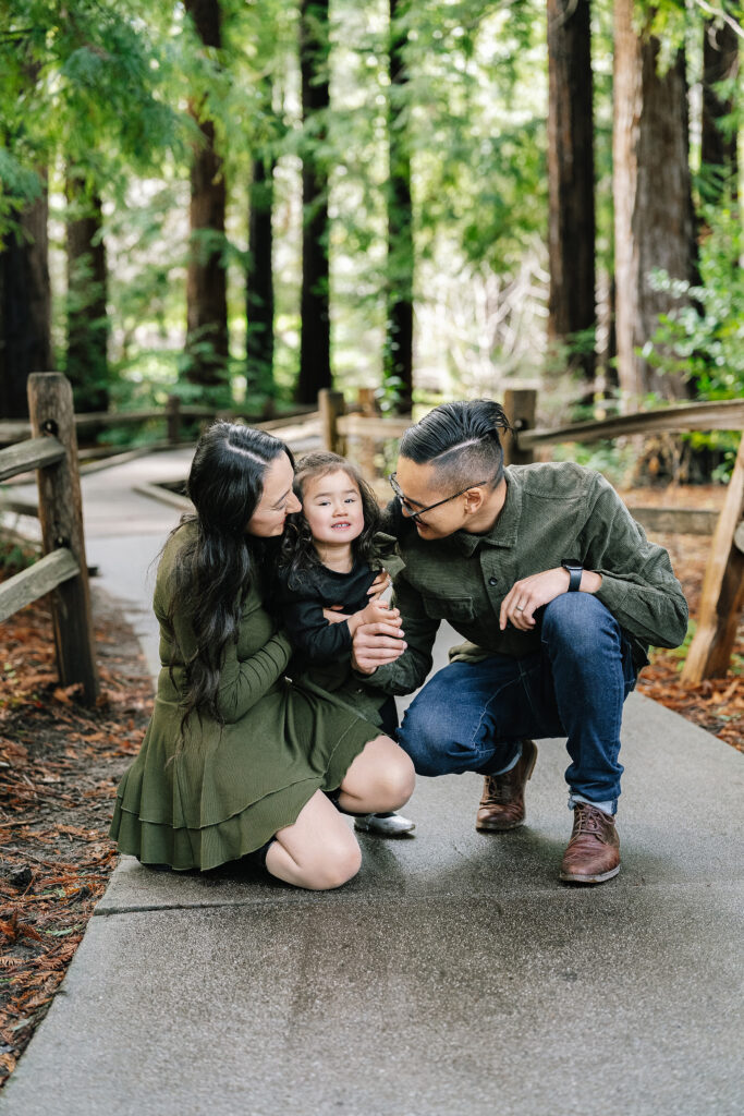 Family photography at Redwood Grove Nature Preserve Los Altos — parents crouching down with little girl on redwood path